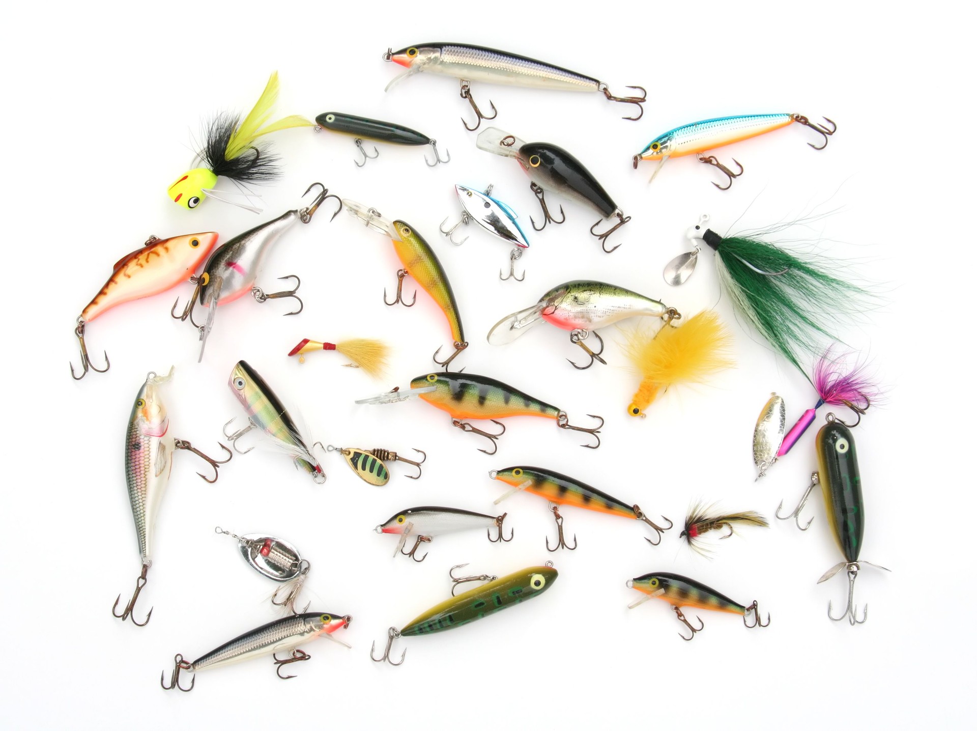 Group of colorful fishing lures with hooks on white background